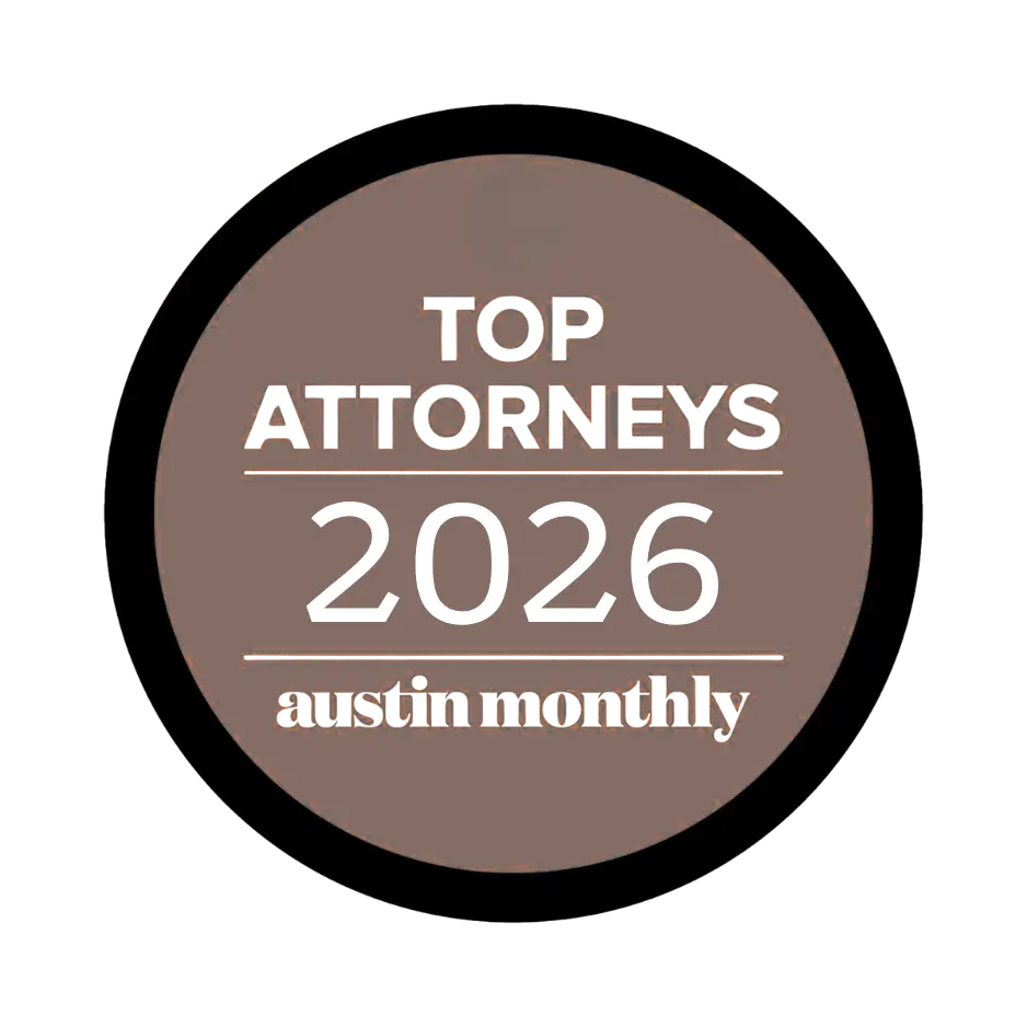 Brown circular badge reading 'TOP ATTORNEYS' with '2026' and 'Austin Monthly' — award badge.