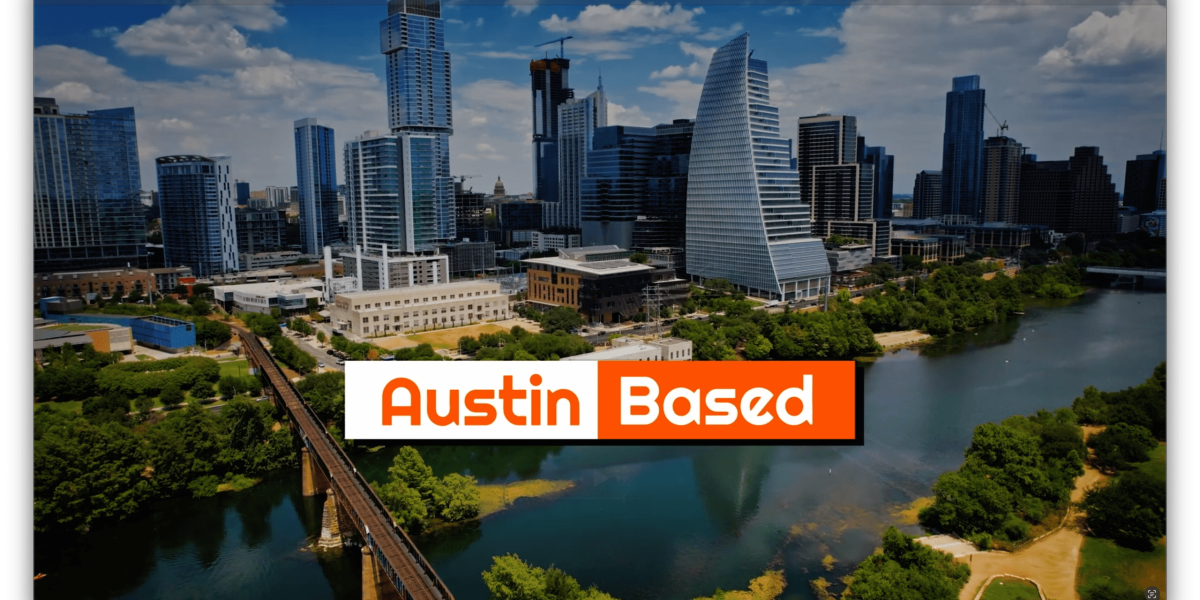 Aerial view of downtown Austin with modern skyscrapers, a river in the foreground, and a bridge crossing the water; banner reads 'Austin Based' in orange.